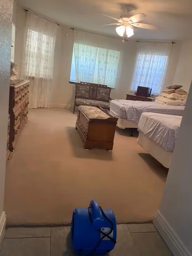 A bedroom carpet being dried after a water loss