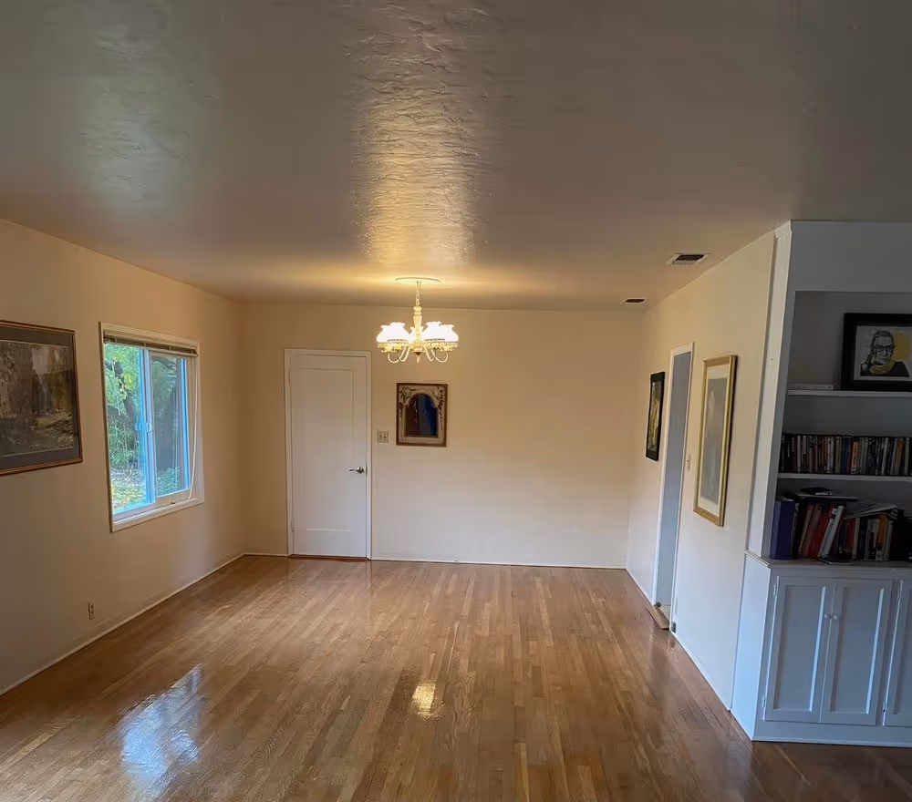 Refinished hardwood running the length of a living room