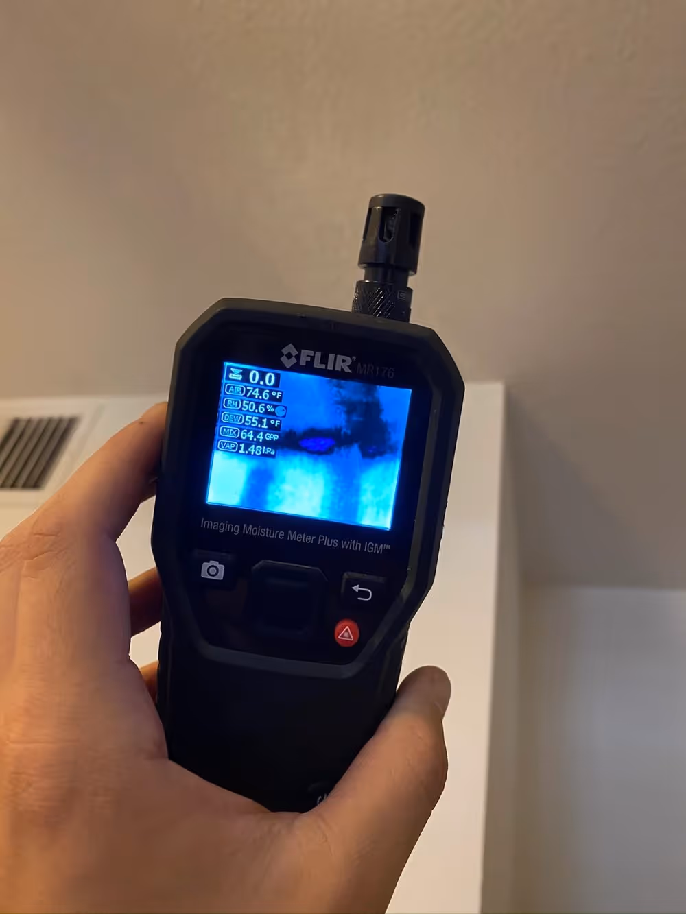 A thermal imaging camera used to trace where water has traveled behind a wall