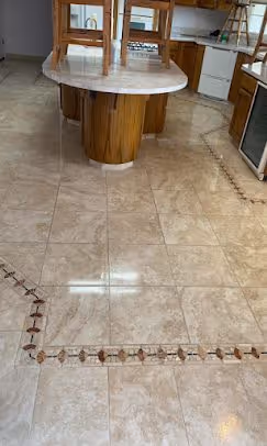 A tile floor with a decorative inlay, cleaned and re-sealed