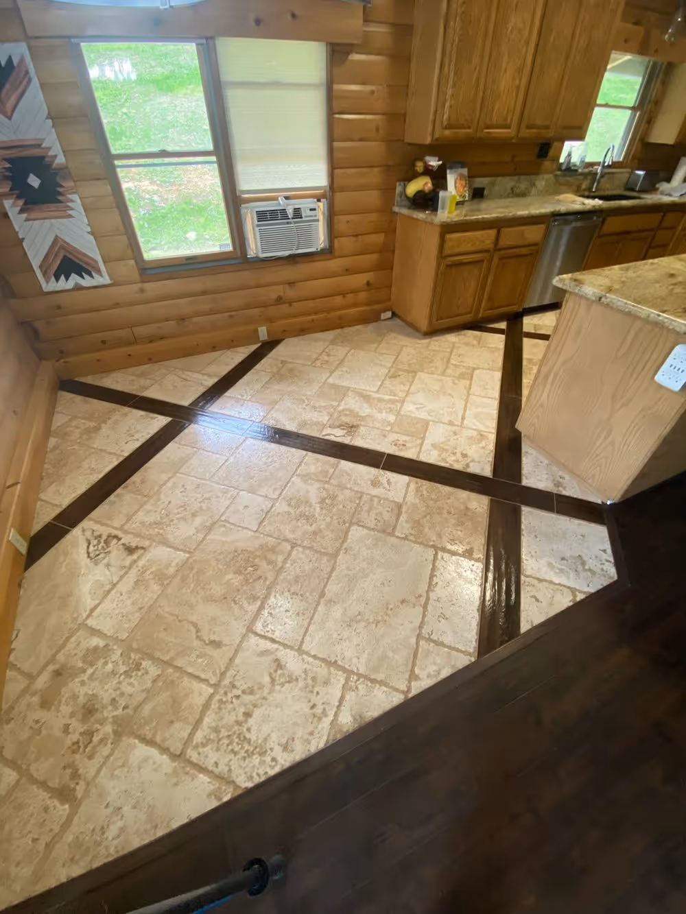 Travertine tile running through a kitchen and out to the hall