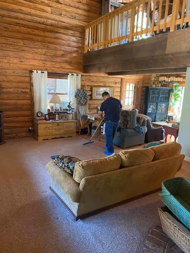 Upholstered seating being cleaned in a log-built living room