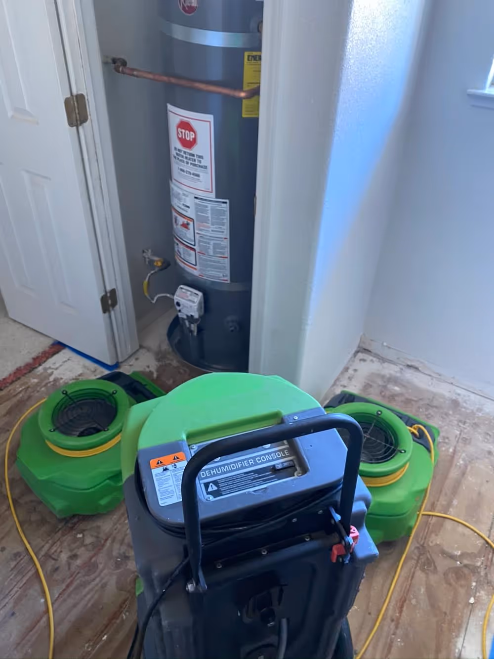 Air movers set up around a failed water heater